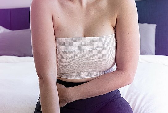 a woman with a bandaged chest
